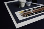 Load image into Gallery viewer, Medium set for Arabic calligraphy, 4 dip qalam pens with left oblique nibs, walnut ink, silk likka, inkwell, pen rest, notebook
