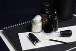Load image into Gallery viewer, Large set for Arabic calligraphy - 7 dip pens, 2 notebooks, pen stand, black Taher ink, rose water, inkwell, silk likka, porcupine quill, transfer pipette, pen rest
